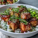 Sriracha mayo drizzles over this colorful Salmon Rice Bowl, with green onions and sesame seeds adding texture.