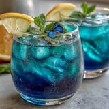 An easily made, refreshing Butterfly Pea Flower Lemonade turning purple with a lemon twist.