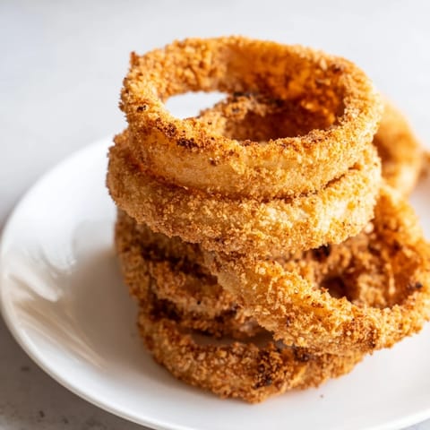Freshly fried onion rings, a perfect snack with a delightful, golden crunch and flavor.